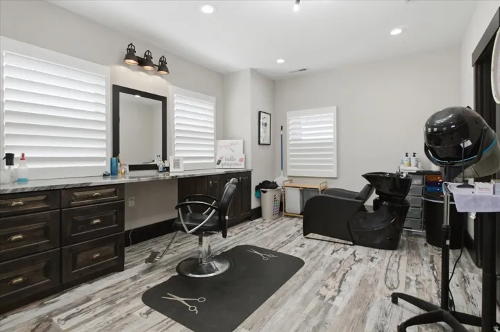 Wood-finish flooring, custom dark wood cabinetry, and solid surface countertops