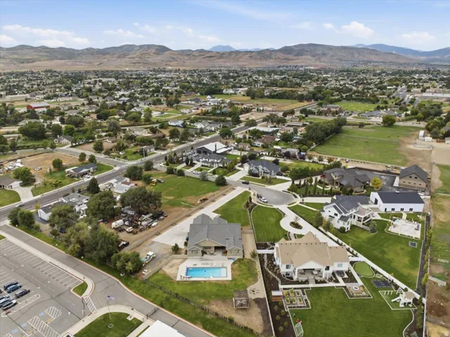 Expansive property featuring a private swimming pool, manicured lawn, and mature trees