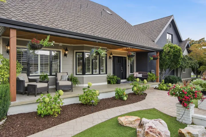 Front exterior with covered porch, multiple gables, and shake-style roofing