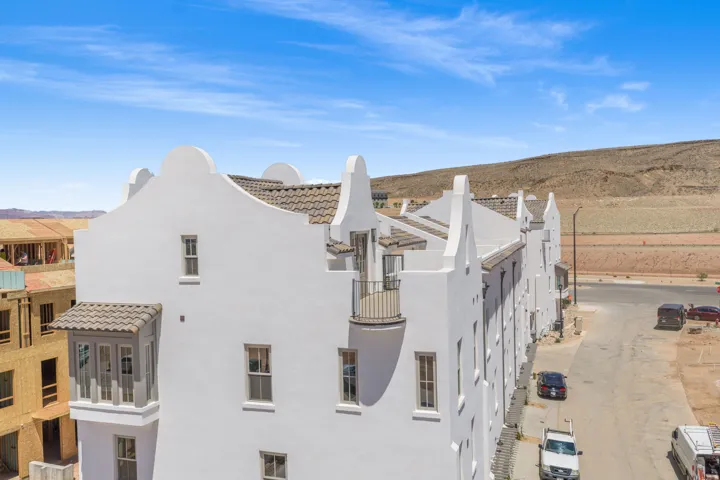 White stucco exterior with a clay tile roof