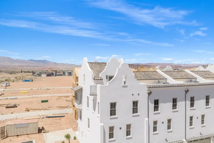 Whitewashed stucco exterior with multiple gabled rooflines