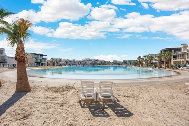 Expansive sandy beach area with a large artificial lagoon