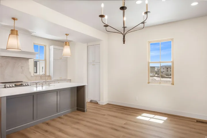 Expansive central island with quartz countertop and panel detailing