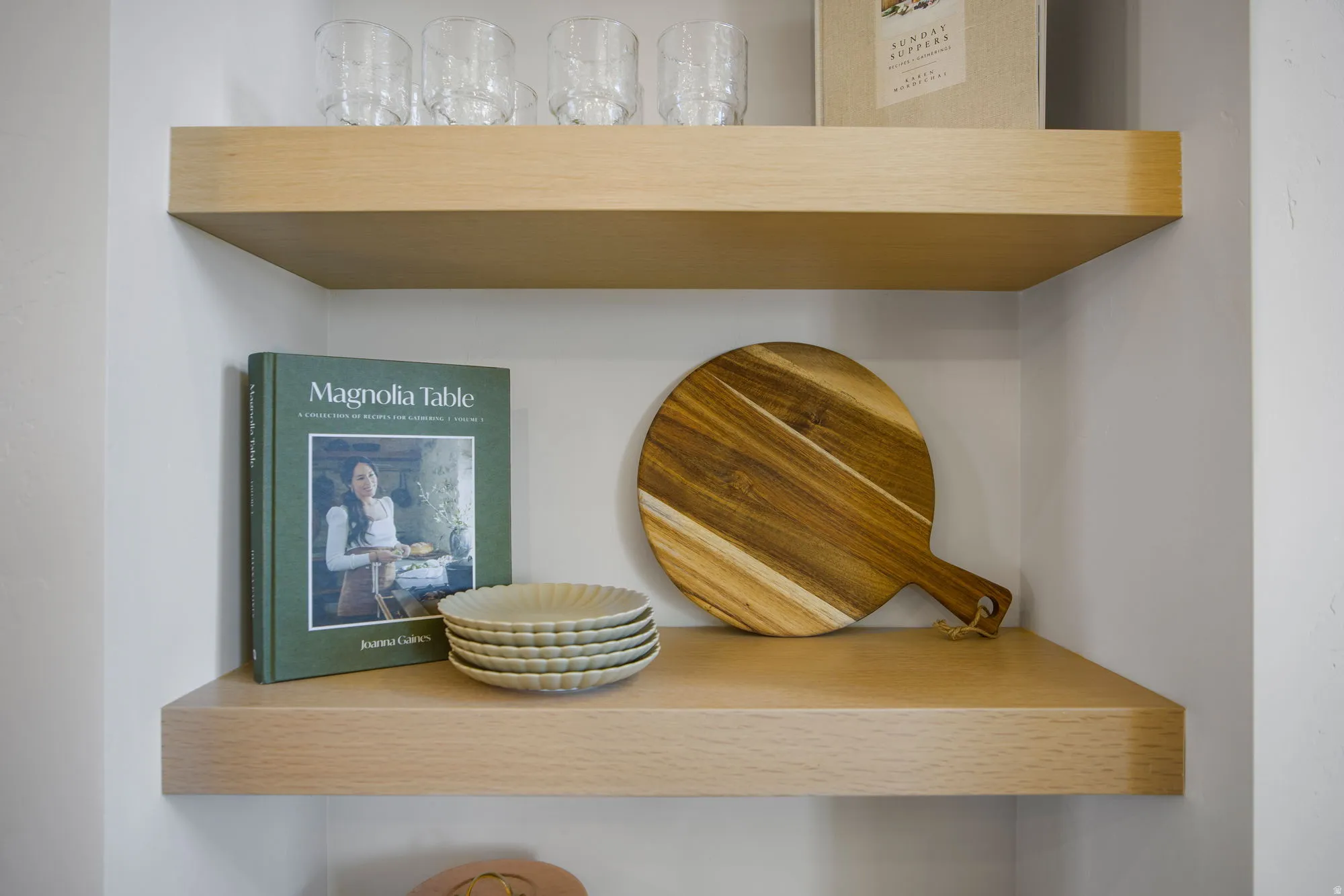 Built-in floating wooden shelves within an alcove