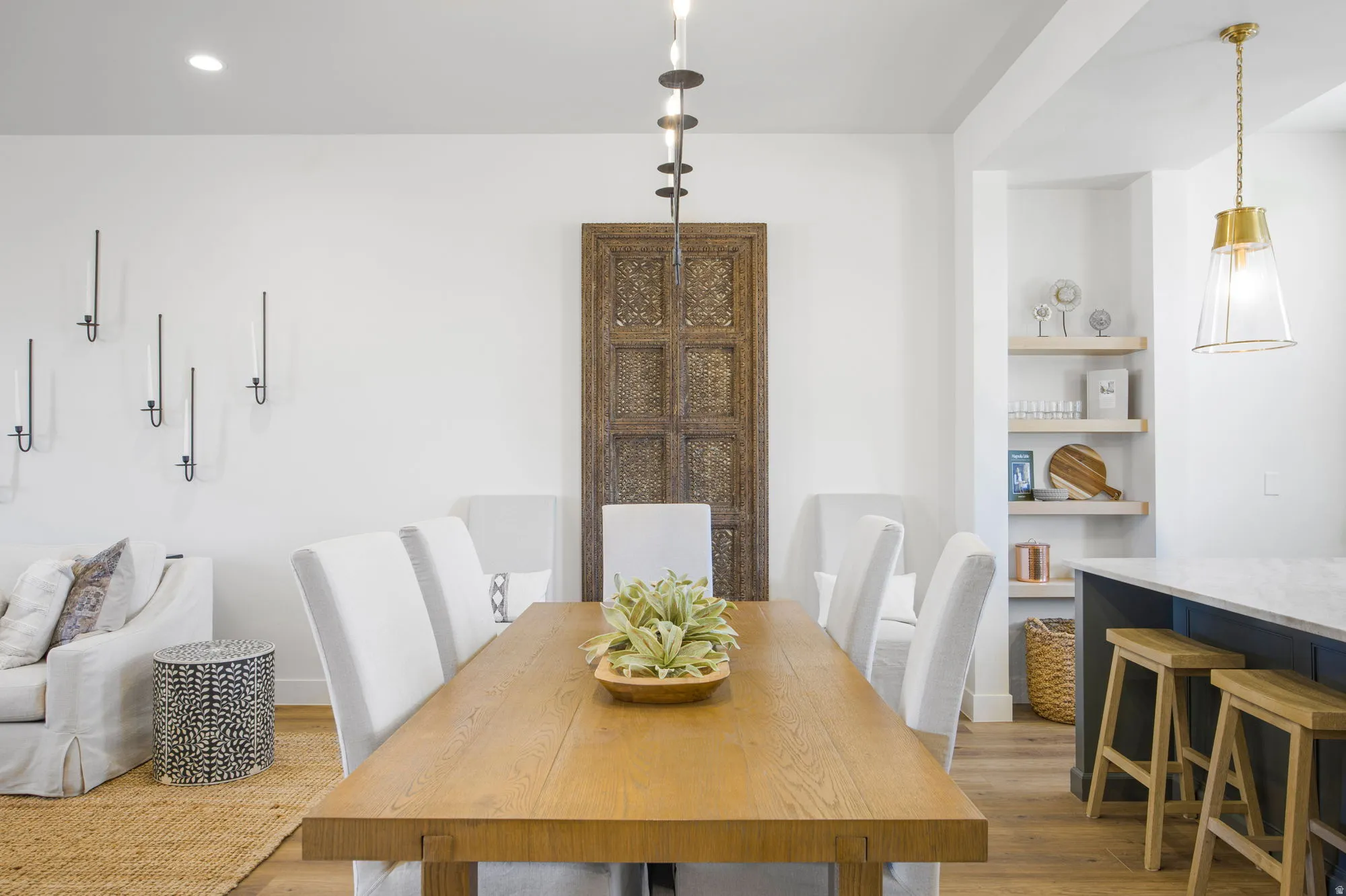 Spacious dining area with wood-finish flooring, recessed lighting, and a modern chandelier