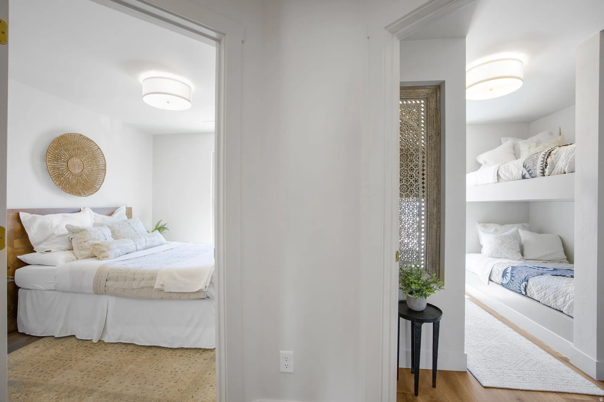 Hardwood-style flooring extends through the hallway, leading to two distinct bedroom spaces