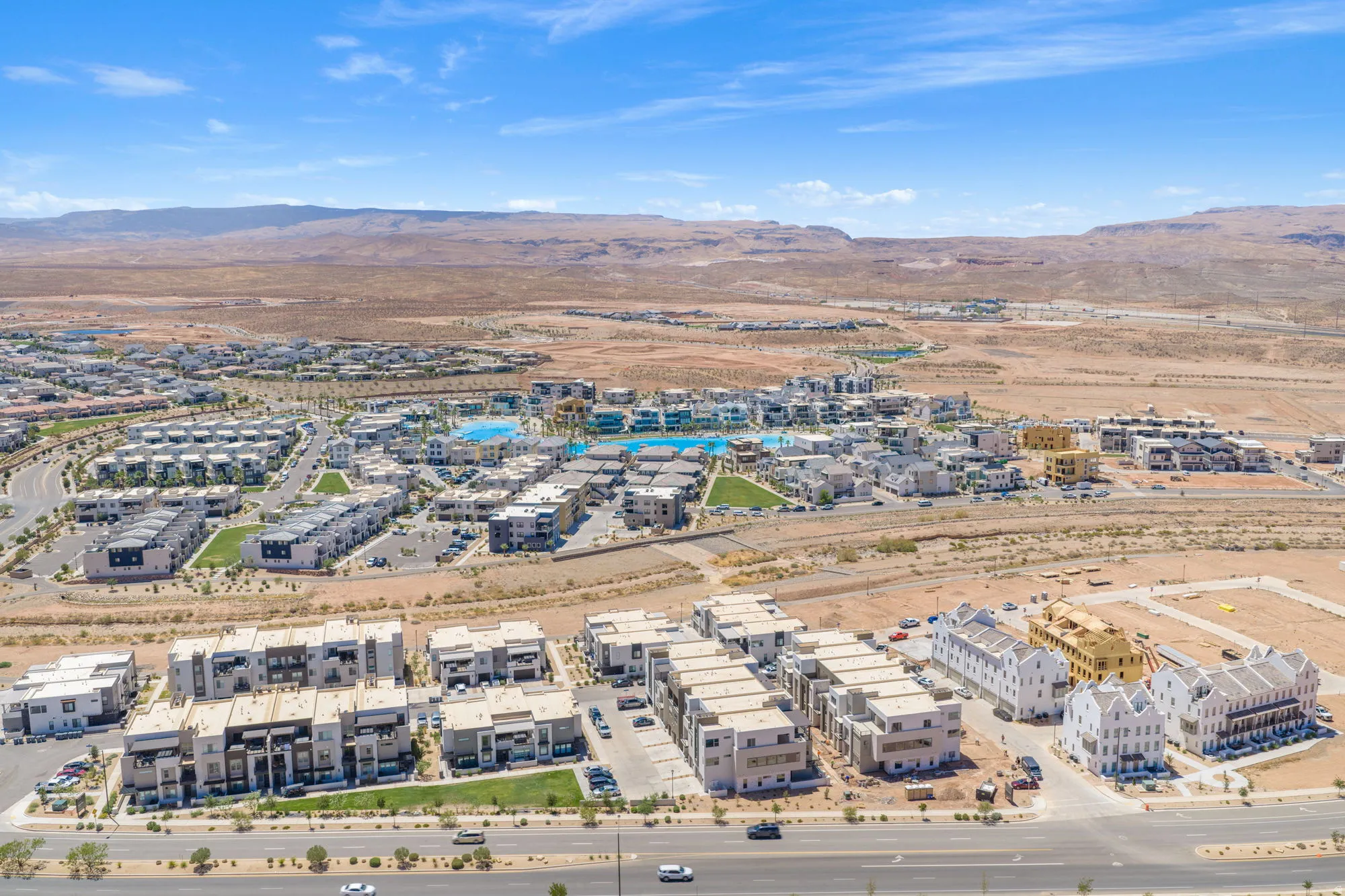 Expansive residential development featuring multiple structures, paved roads, and integrated green spaces