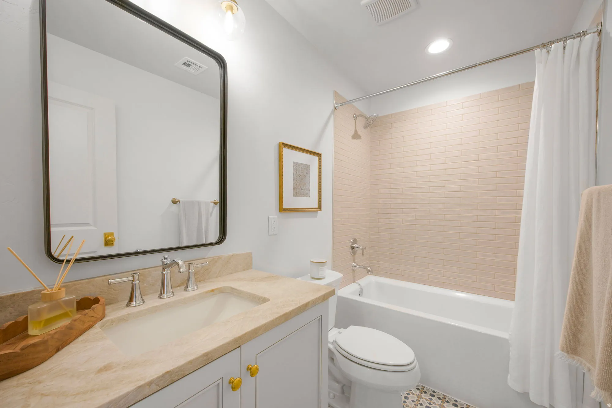 Vanity with a built-in sink and natural stone countertop