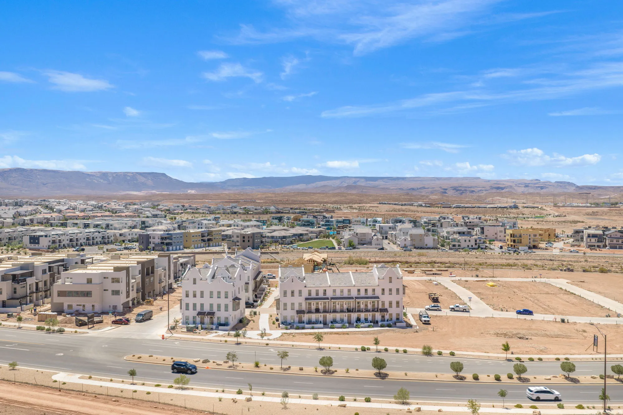 Modern residential development featuring multi-story buildings and a paved road network