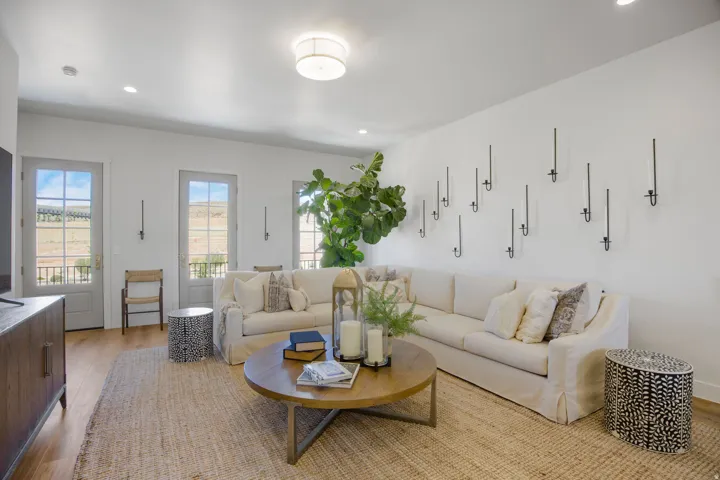 Recessed lighting, wood-finish flooring, and multiple French doors with transoms
