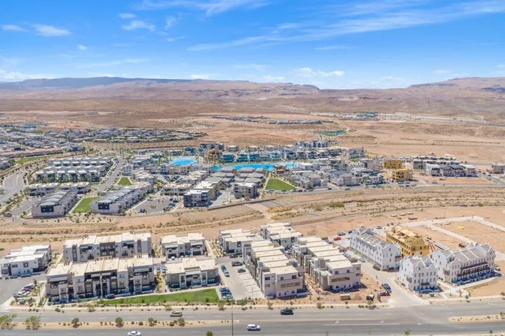 Expansive residential development featuring multiple structures, paved roads, and integrated green spaces