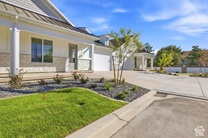 Modern farmhouse exterior showcasing a composite shake and stone facade, white trim detailing, and a gabled roofline