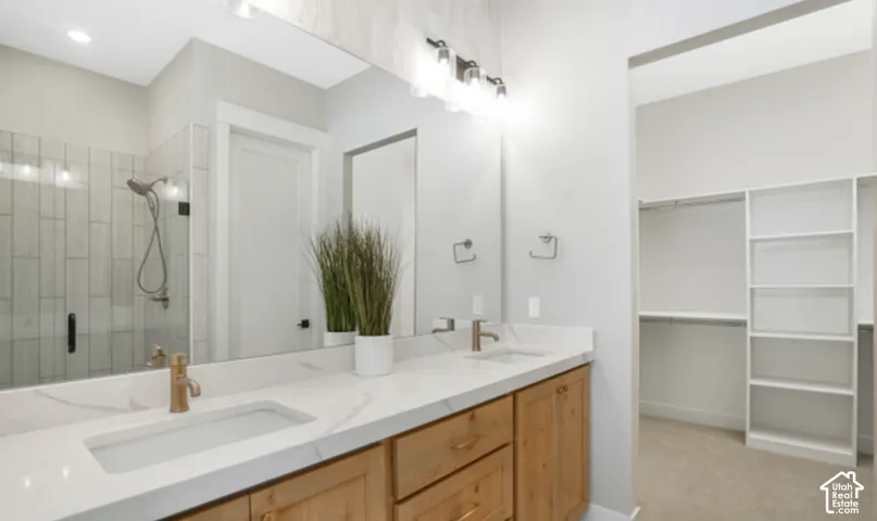 Double vanity with integrated sinks and bronze-finish faucets, set on a light-toned countertop