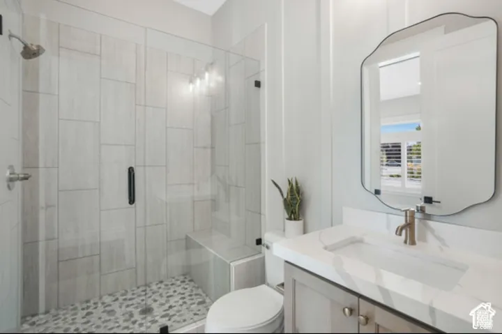 Glass-enclosed shower with a built-in bench and pebble flooring