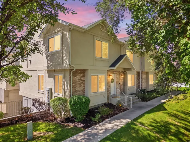 Multi-story exterior with stucco and brick accents
