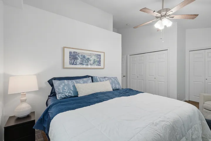Recessed wall feature, ceiling fan with light, and multiple built-in closet doors