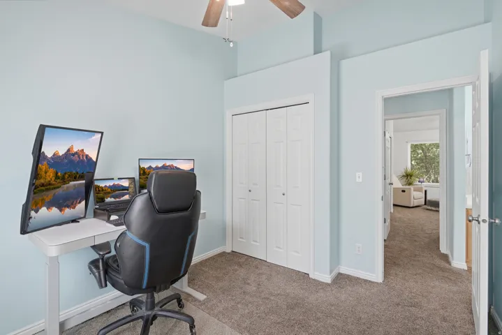 Vaulted ceiling, ceiling fan, bi-fold closet doors, light blue wall paint, carpeted flooring