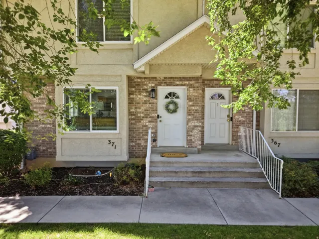 Multi-story exterior featuring brick and stucco siding