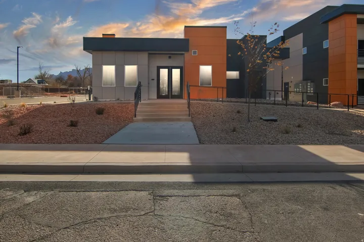 Modern architectural facade featuring contrasting grey and orange panels