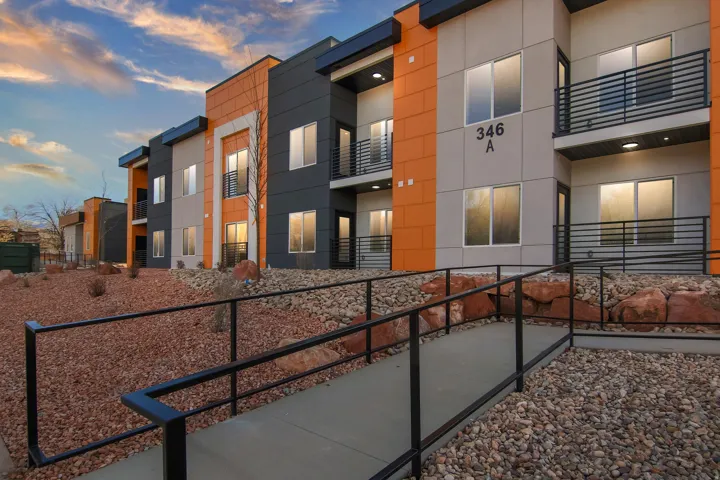 Multi-story building with a contemporary facade featuring orange and gray paneling