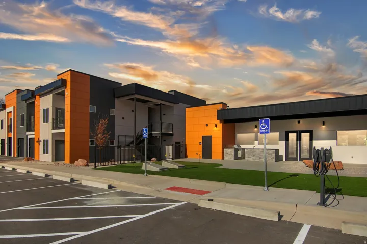 Modern multi-story buildings featuring vibrant orange and gray exterior panels