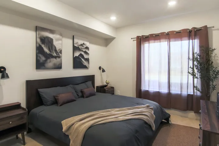 Built-in recessed lighting, wood-finish flooring, and a window with curtain rod installation