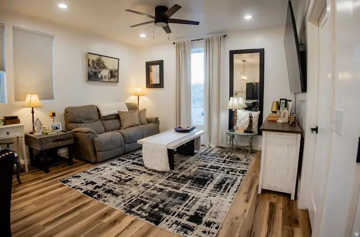 Wood-finish flooring throughout, recessed lighting, and a ceiling fan