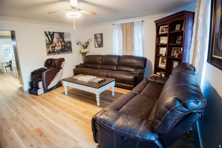Wood-finish flooring throughout, bright white walls, and crown molding