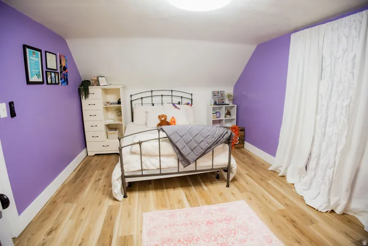 Sloped ceiling interior with wood-finish flooring