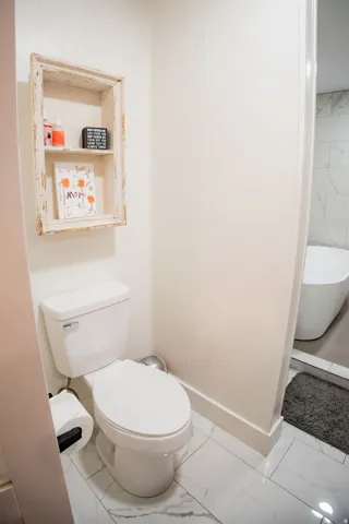 White paneled walls with a built-in wall shelf