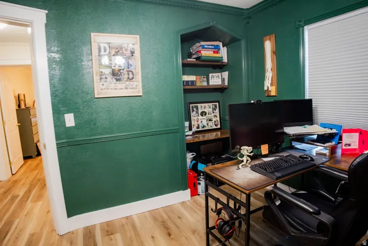 Built-in shelving, wood-finish flooring, and white trim