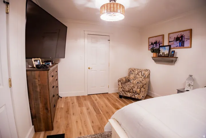 Recessed lighting fixture, wood-finish flooring, white panel doors, and white baseboards