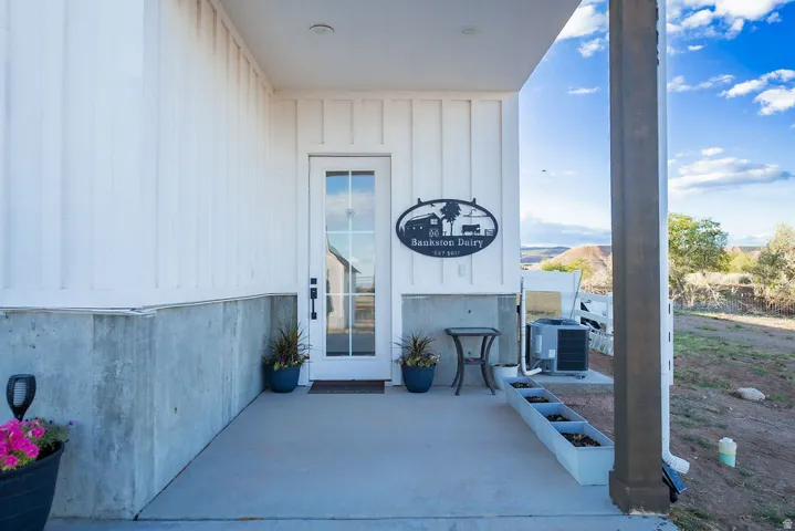 White board and batten siding with a concrete foundation