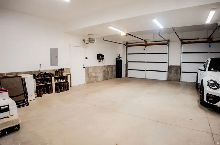 Two-car garage featuring concrete flooring, white walls, and bright overhead lighting