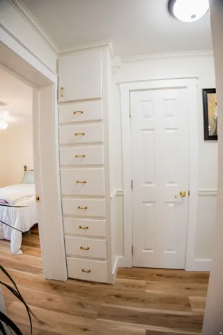 Built-in vertical cabinetry with brass hardware