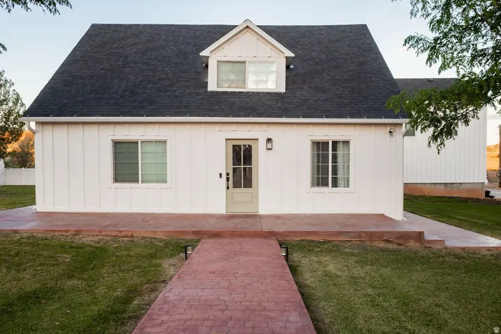 White board and batten siding with dark shingle roofing