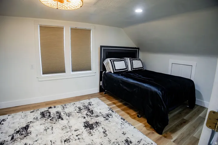 Wood-finish flooring, recessed lighting, and a sloped ceiling
