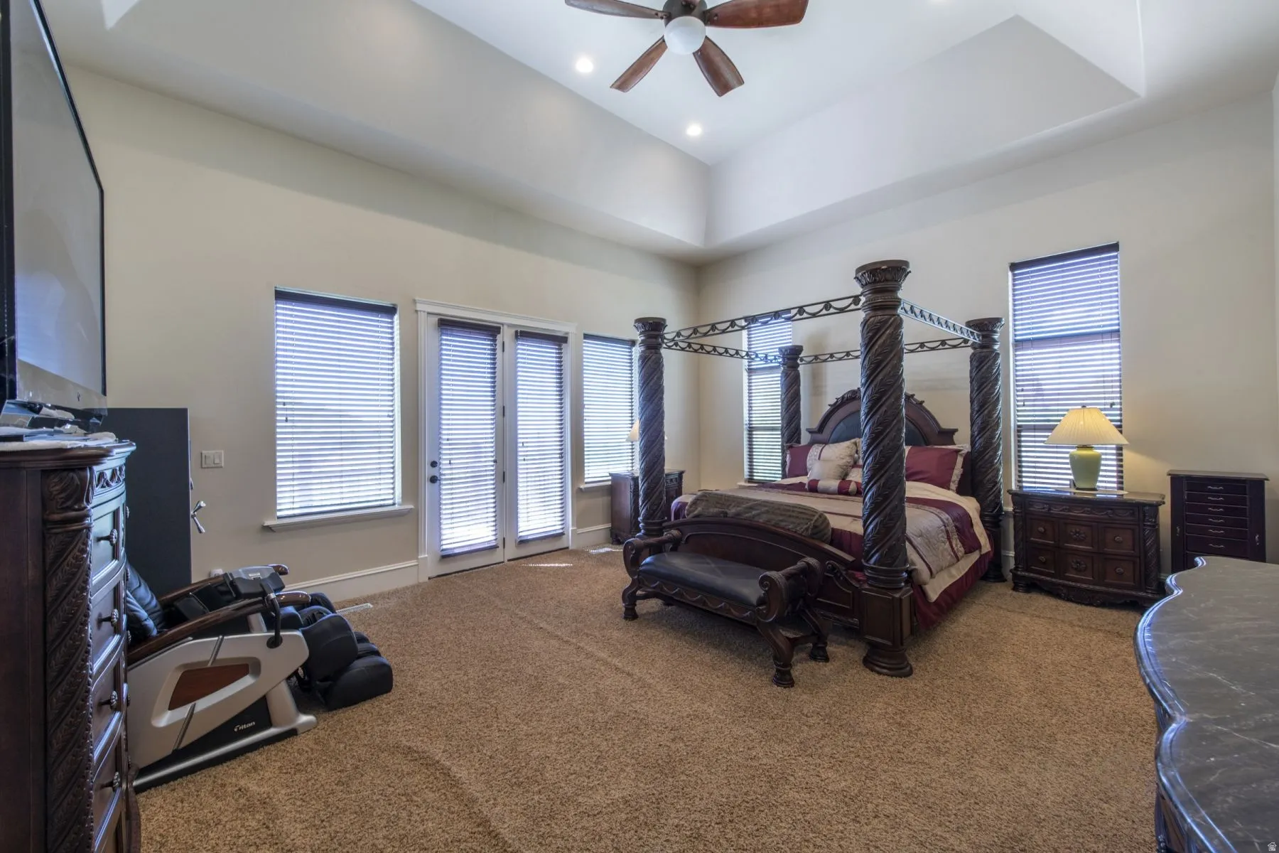 Room featuring a tray ceiling, recessed lighting, and a ceiling fan
