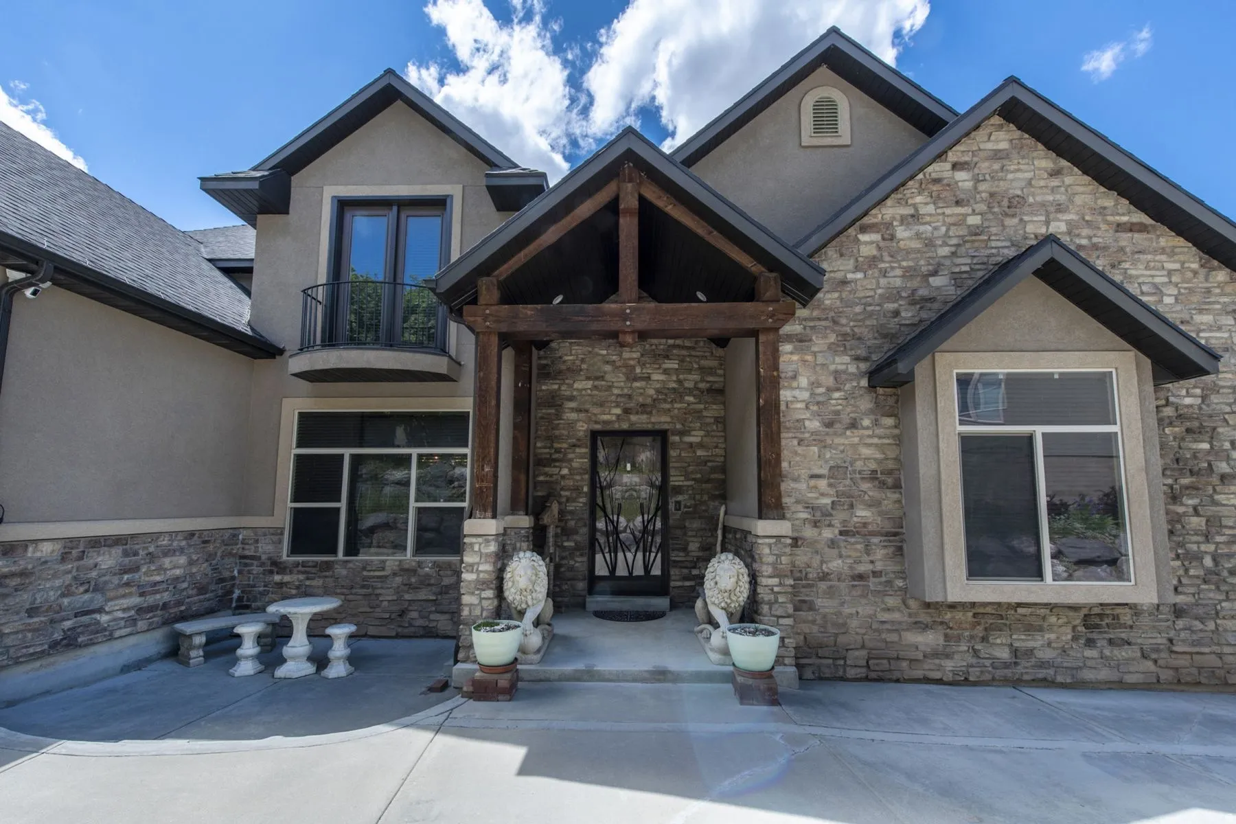Stone and stucco exterior with multiple gables
