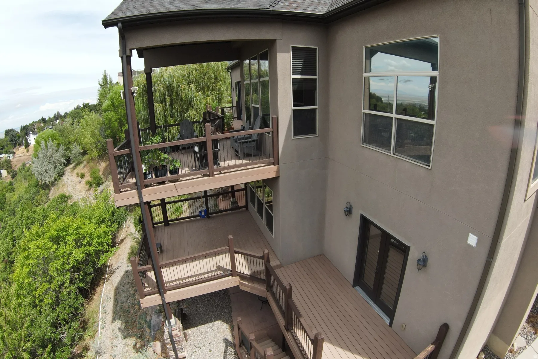 Multi-level decking with composite material, black metal railings, and built-in steps