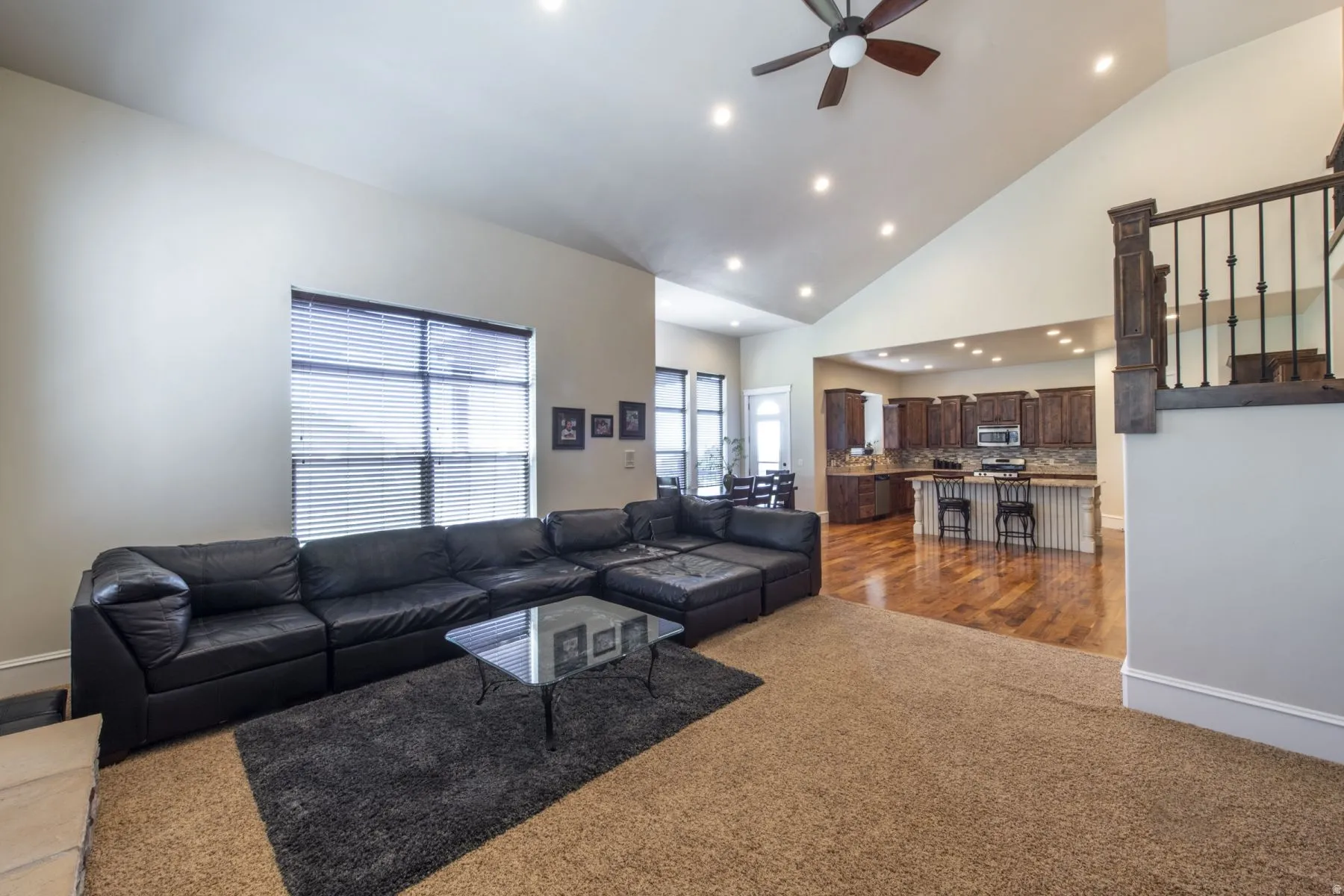 Vaulted ceiling with recessed lighting and a ceiling fan