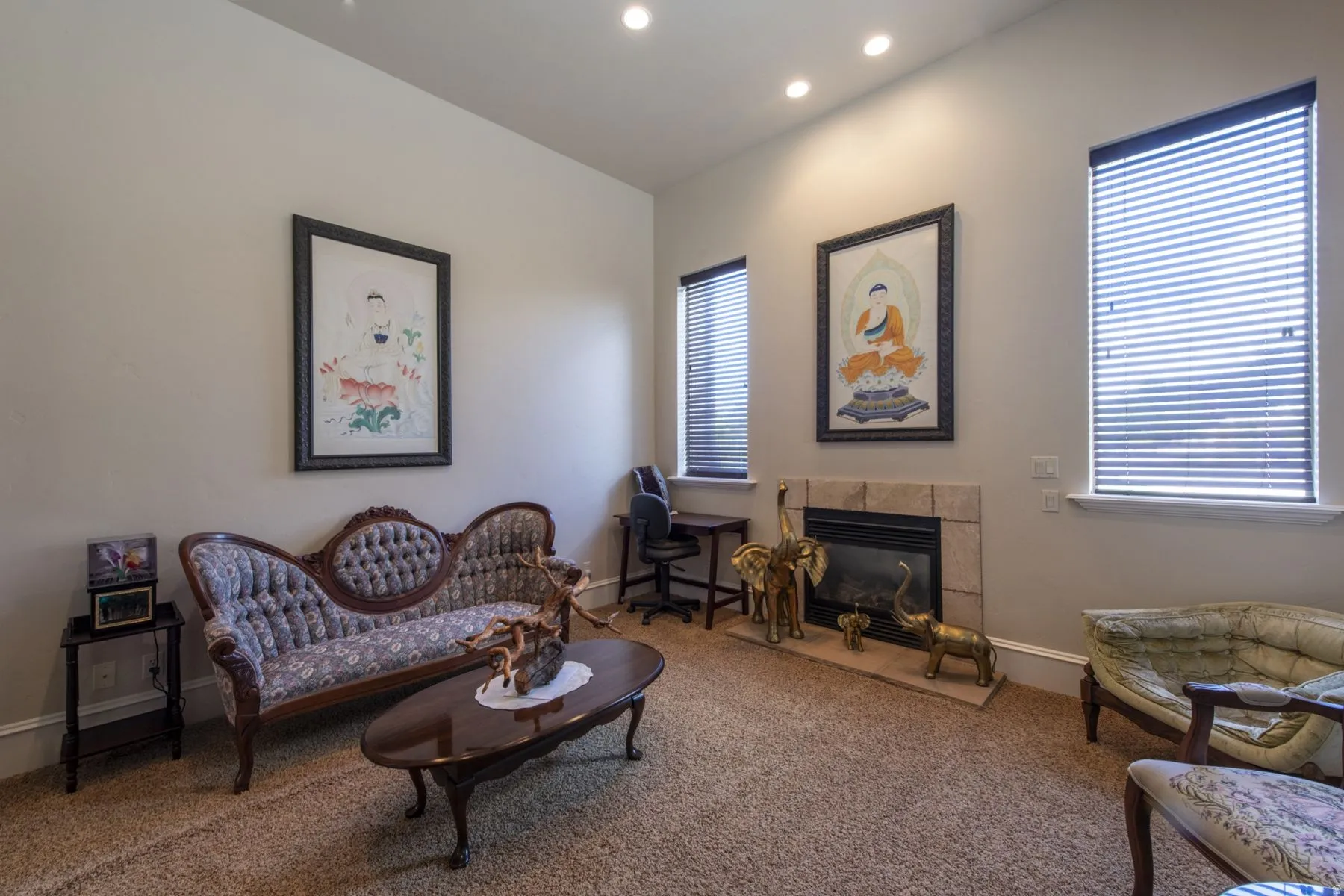 Recessed lighting illuminates a neutral wall color, complemented by two windows with blinds