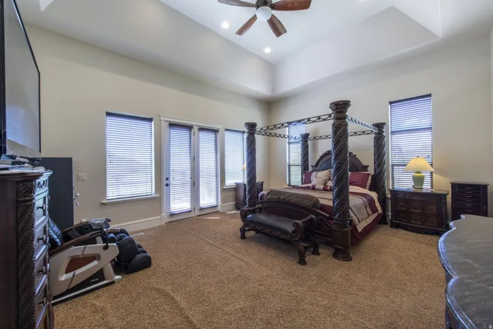 Room featuring a tray ceiling, recessed lighting, and a ceiling fan