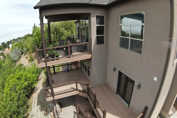 Multi-level decking with composite material, black metal railings, and built-in steps