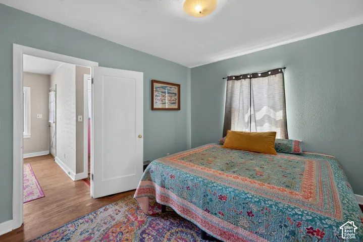 Hardwood flooring, white trim, single window, overhead light fixture