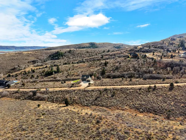 Expansive natural landscape with distant water features and a clear sky