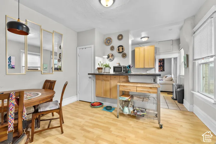 Wood-finish flooring, integrated cabinetry, integrated ceiling lighting, and multiple windows
