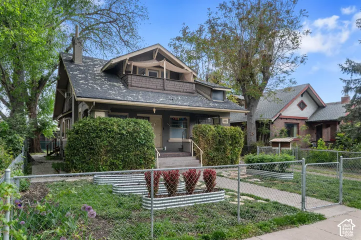Craftsman-style facade with a prominent chimney and a covered porch