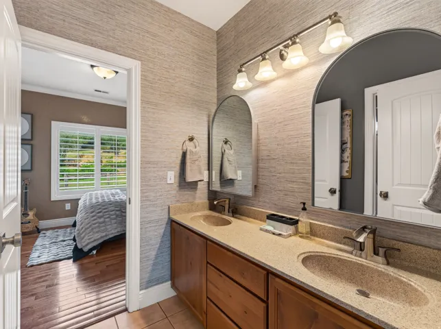 Dual arched mirrors above a vanity with two integrated sinks