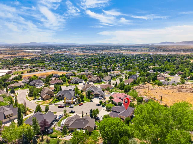Expansive residential area featuring numerous single-family homes, mature landscaping, and a curvilinear street layout